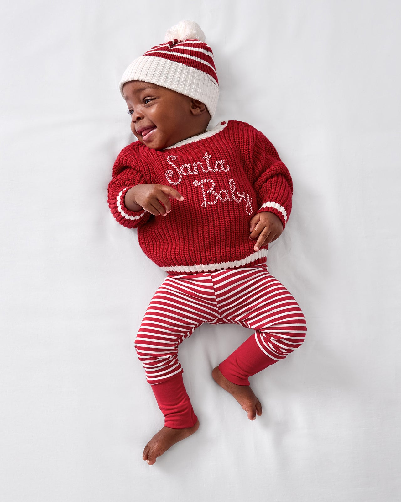 Aerial view of baby wearing the Santa Baby Sweater