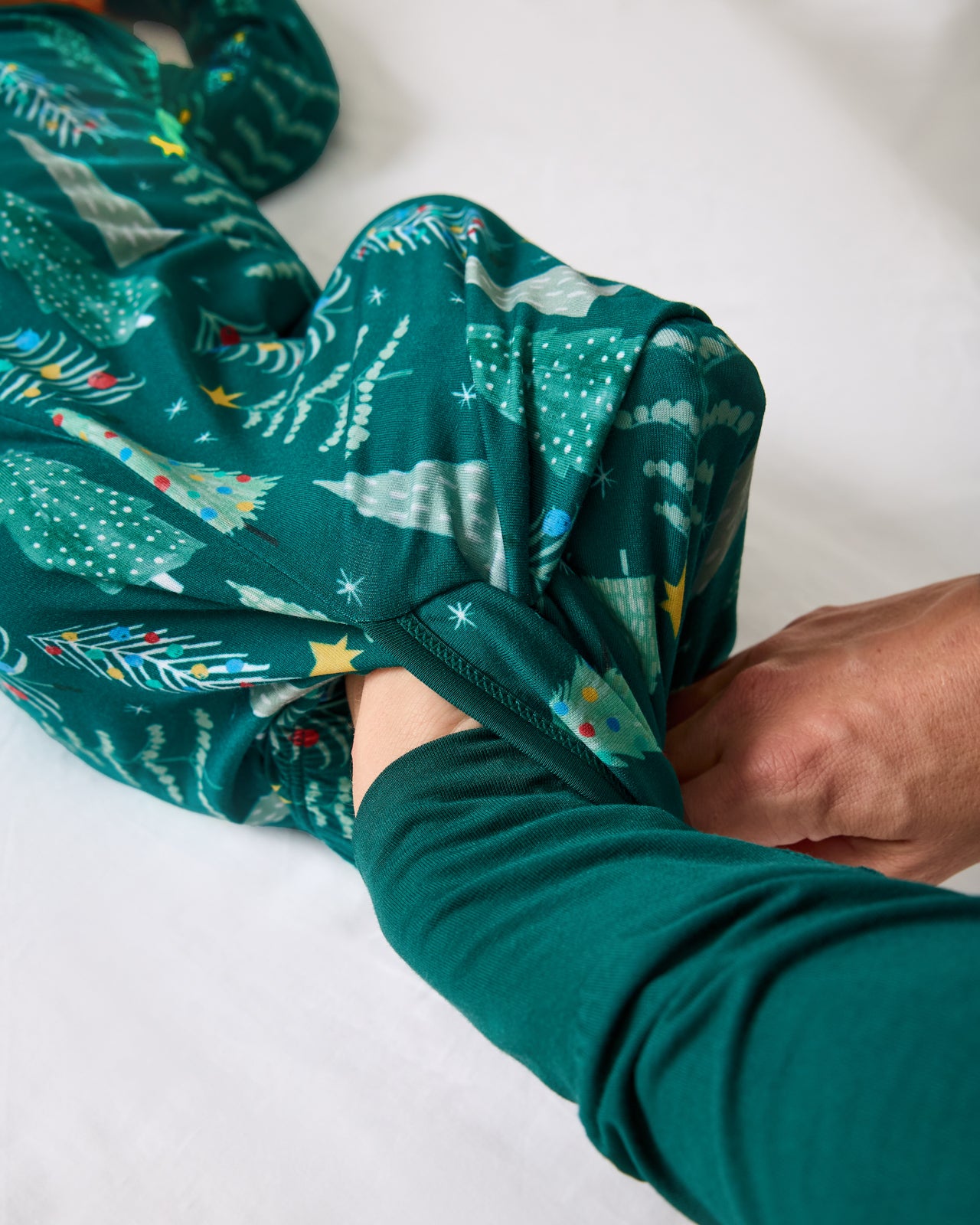 Alternate of adult demonstrating the envelope sweep on the Twinkling Trees Infant Gown