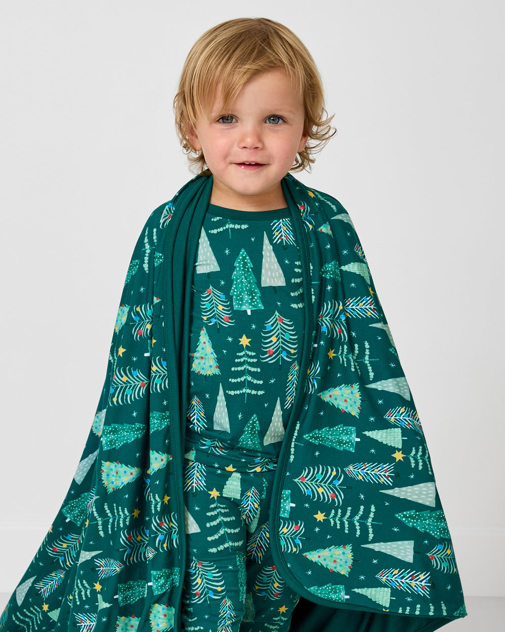 Close up of boy wrapped in the Twinkling Trees Large Cloud Blanket®
