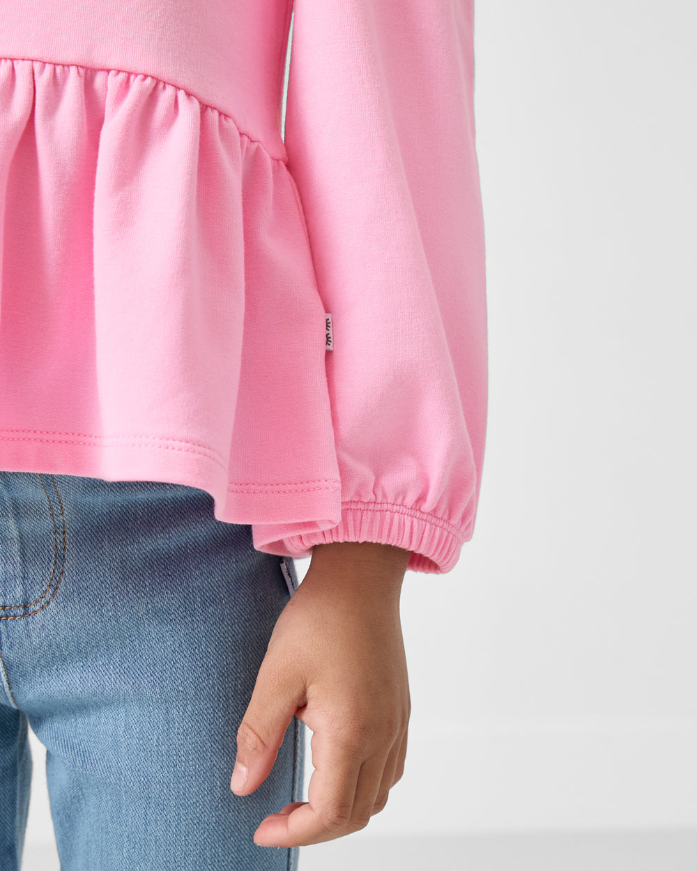 Close up of the wrist cuff on the Gumball Pink Puff Sleeve Peplum Top