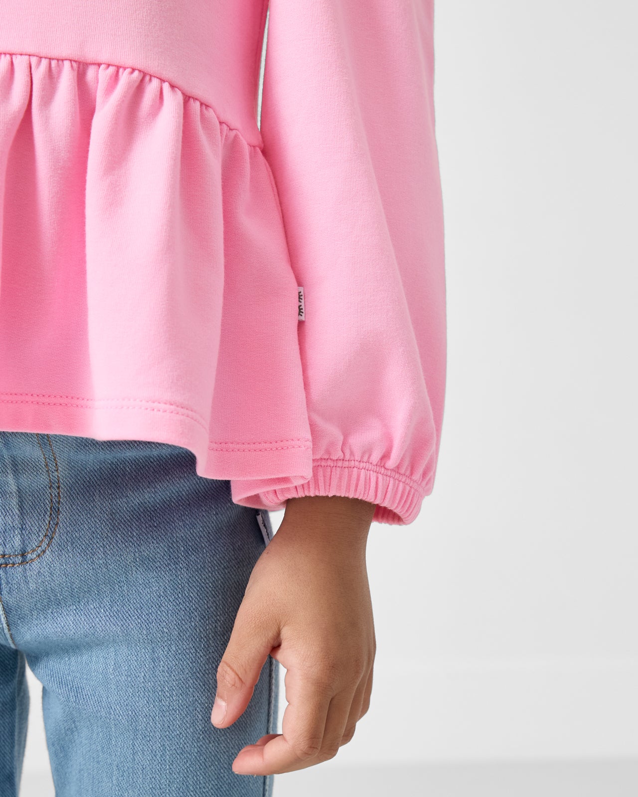 Close up of the wrist cuff on the Gumball Pink Puff Sleeve Peplum Top