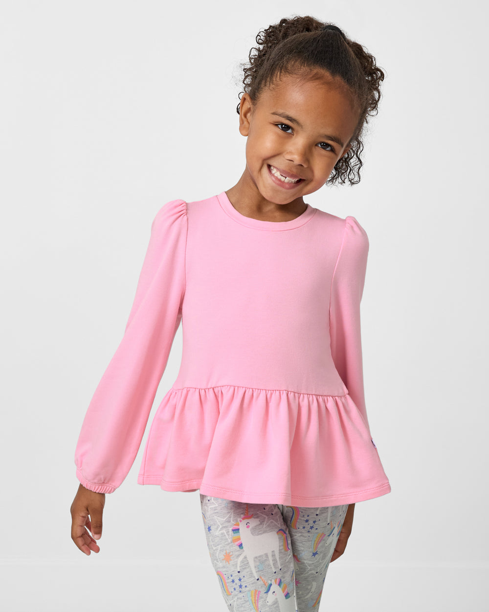 Girl wearing the Gumball Pink Puff Sleeve Peplum Top