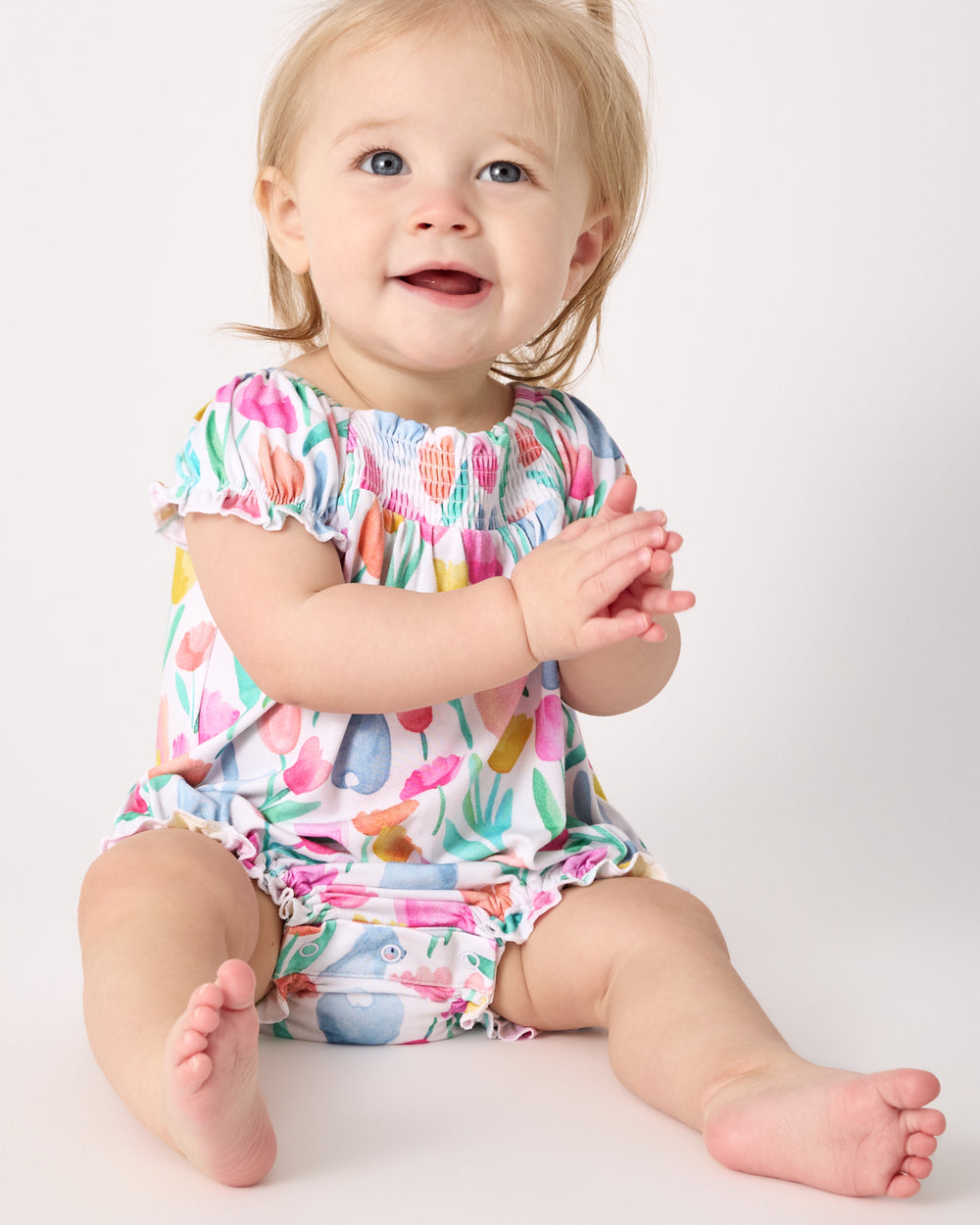 Sitting baby wearing the Garden Hop Smocked Bubble Romper