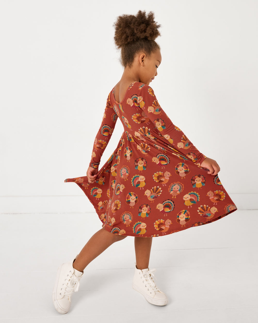 Twirling girl wearing the Grateful Gobbles Twirl Dress