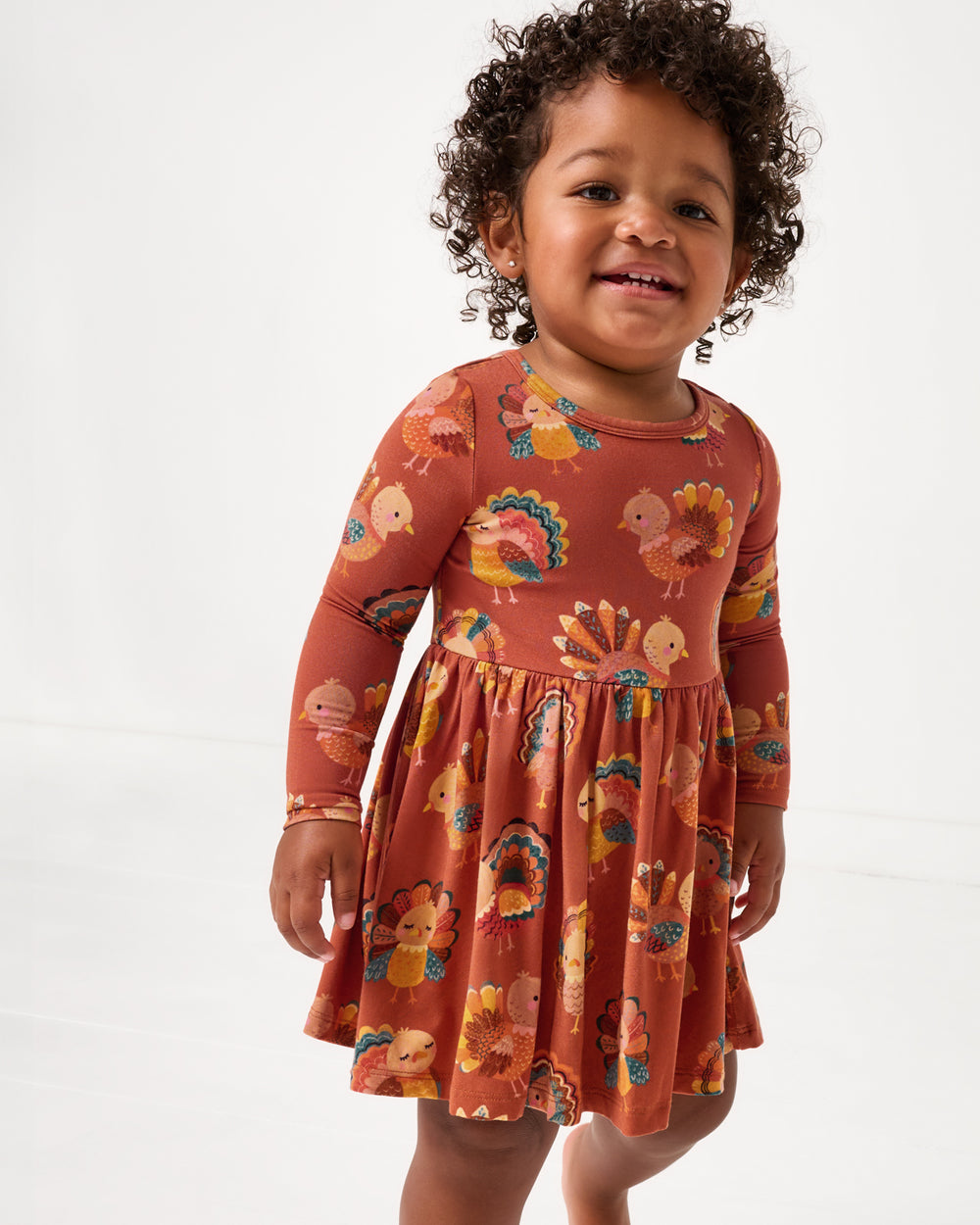Close up of toddler wearing the Grateful Gobbles Twirl Dress with Bodysuit