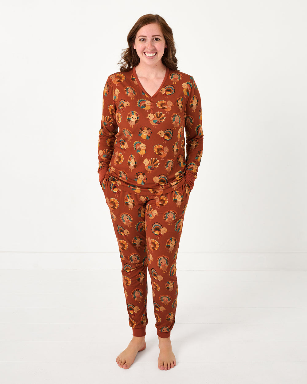 Standing woman wearing the Grateful Gobbles Women's Long Sleeve Pajama Top