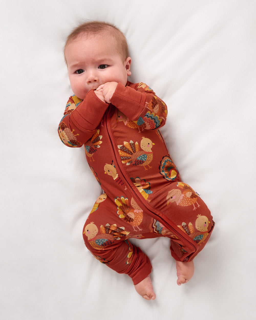 Aerial view of baby wearing the Grateful Gobbles Zippy