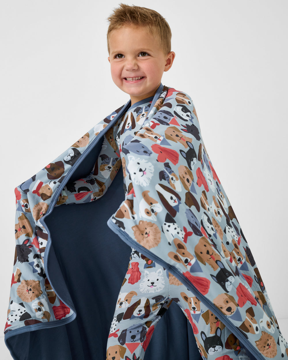 Child in motion wrapped in the Gray Puppy Parade Large Cloud Blanket®