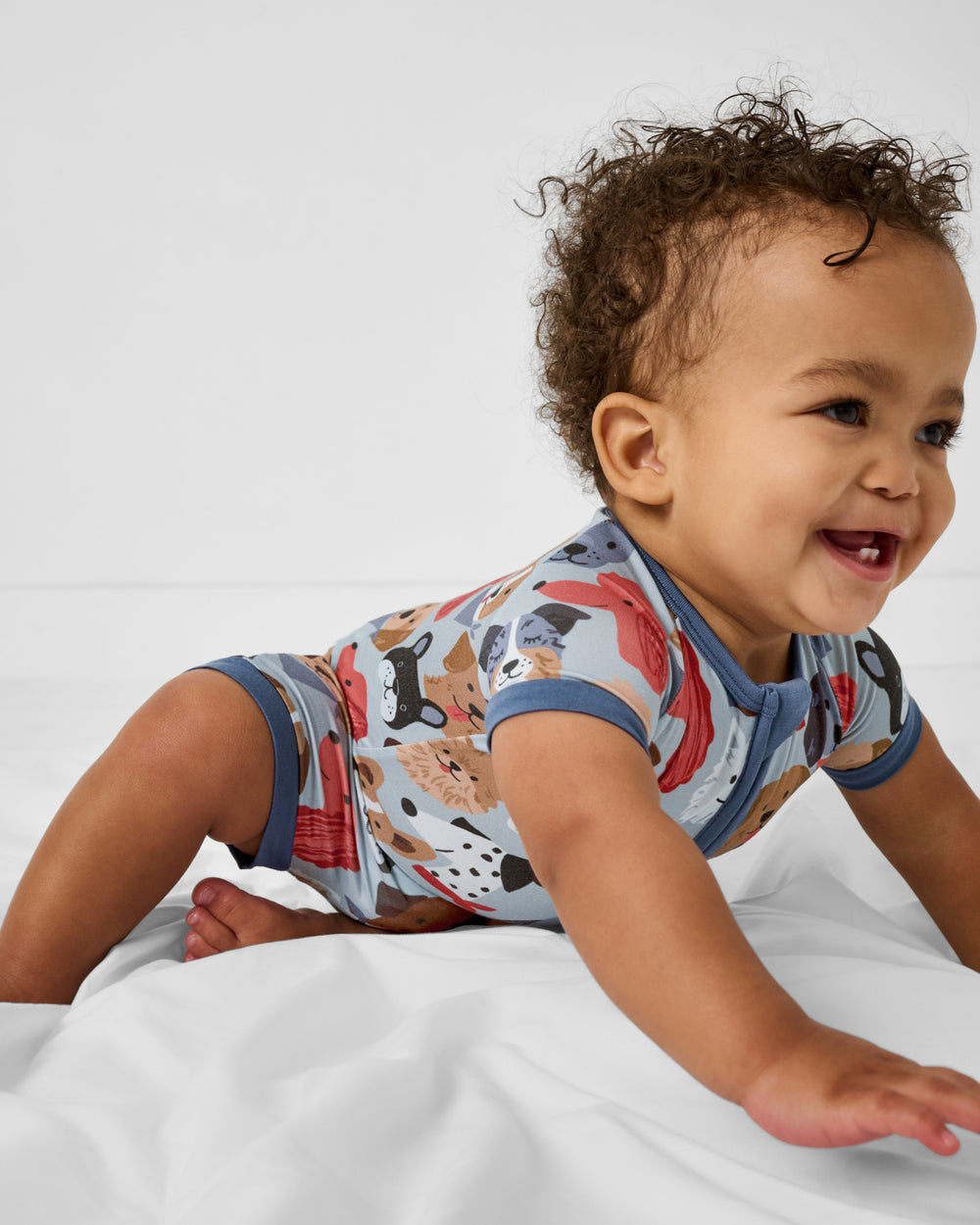 Crawling baby wearing the Gray Puppy Parade Shorty Zippy