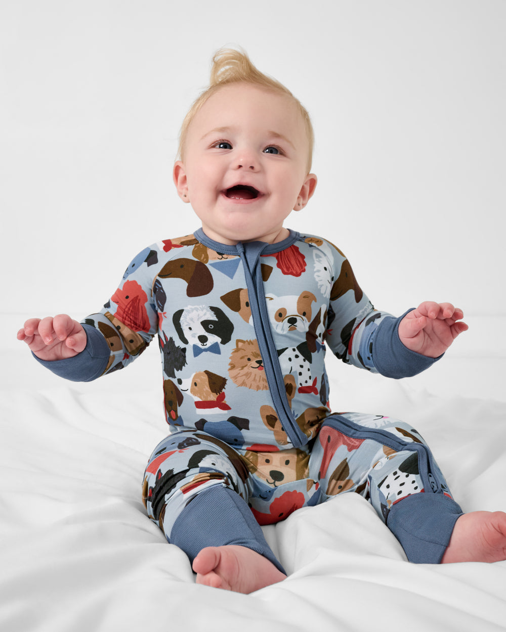 Sitting baby wearing the Gray Puppy Parade Zippy