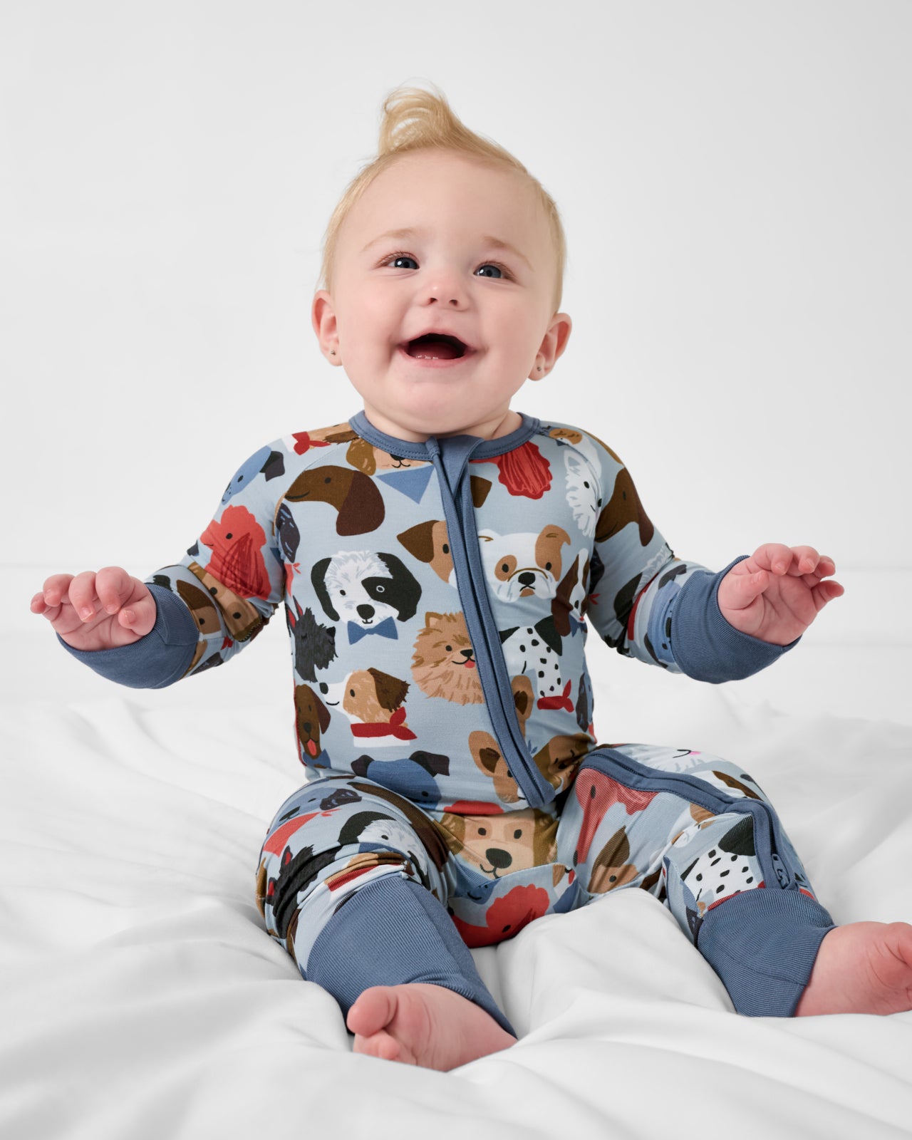 Sitting baby wearing the Gray Puppy Parade Zippy