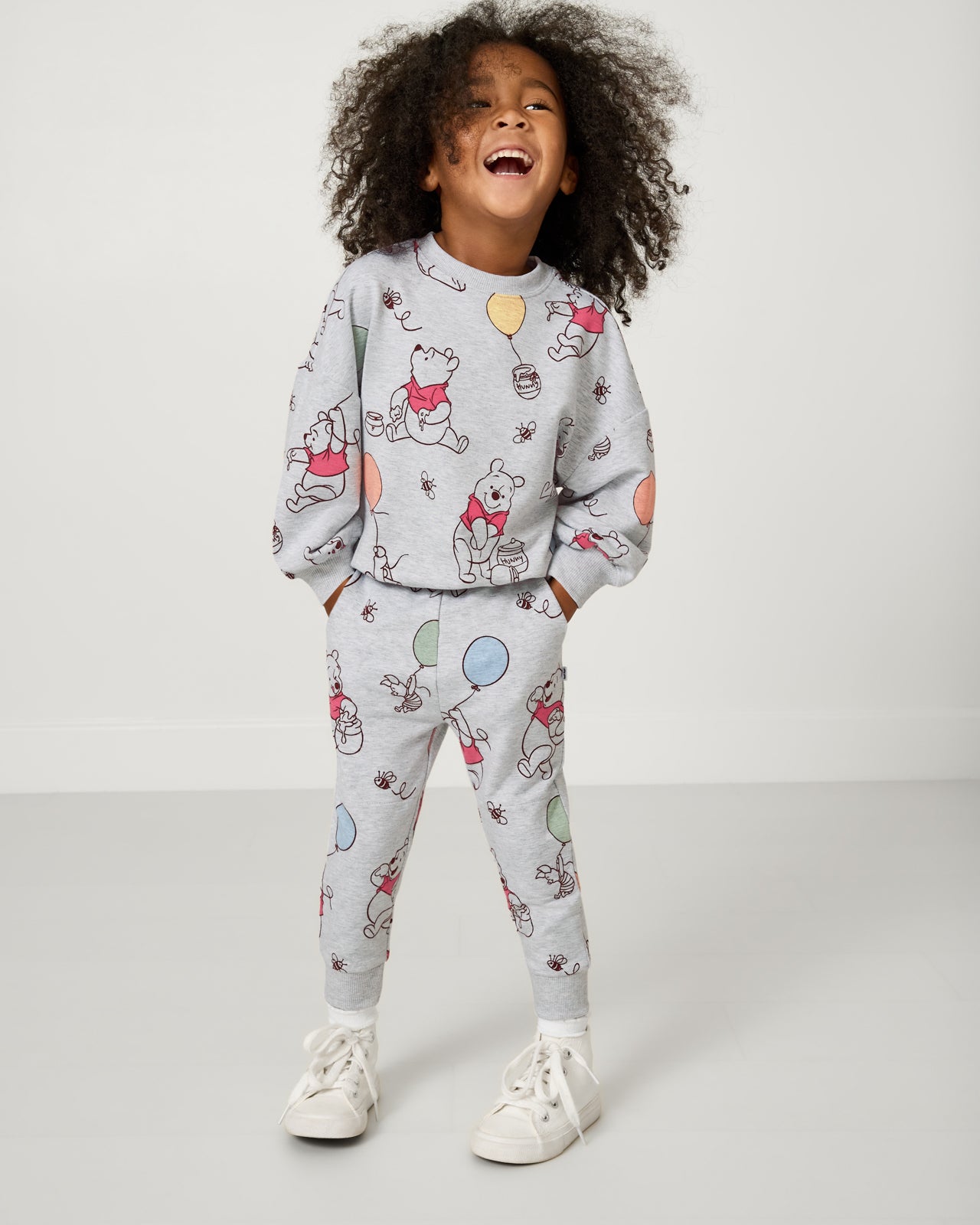 Girl wearing the Disney Up, Up and Away Drop Shoulder Crewneck and joggers