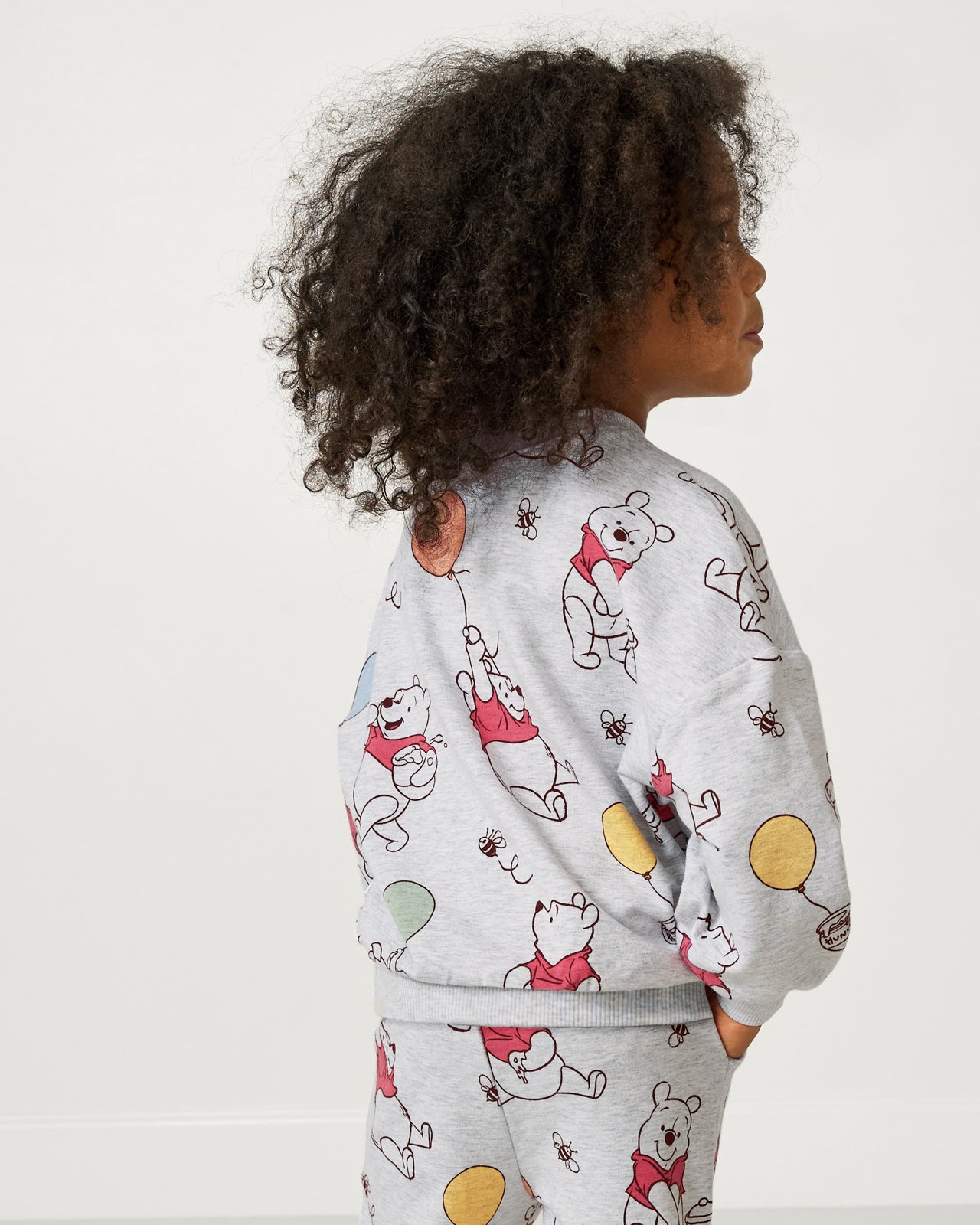 Back view of girl wearing the Disney Up, Up and Away Drop Shoulder Crewneck