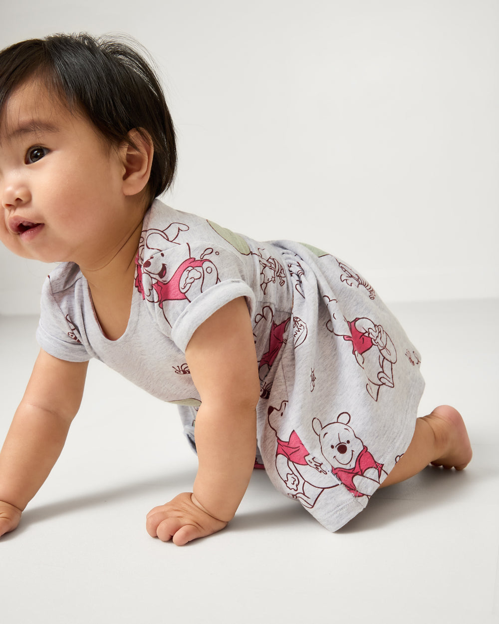Crawling baby wearing the Disney Up, Up and Away Patch Pocket Dress with Bloomer