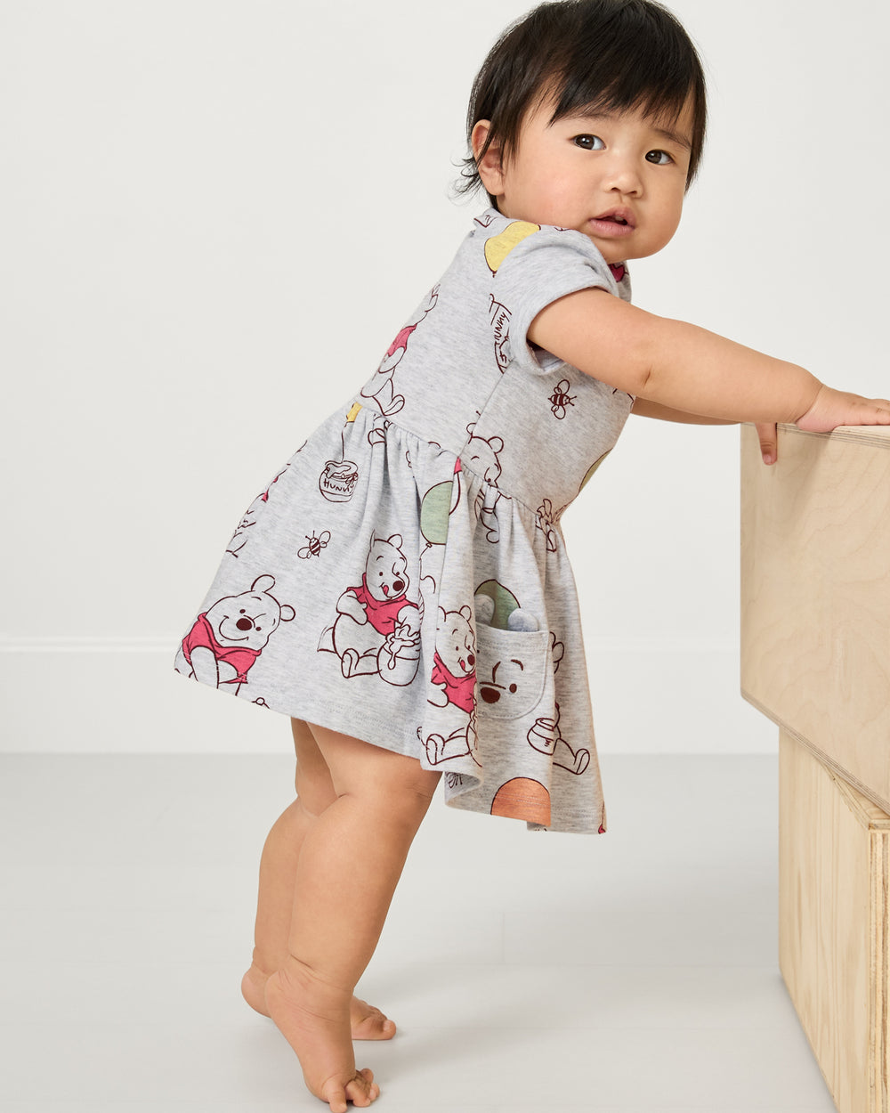 Baby wearing the Disney Winnie the Pooh Up, Up and Away Patch Pocket Dress with Bloomer