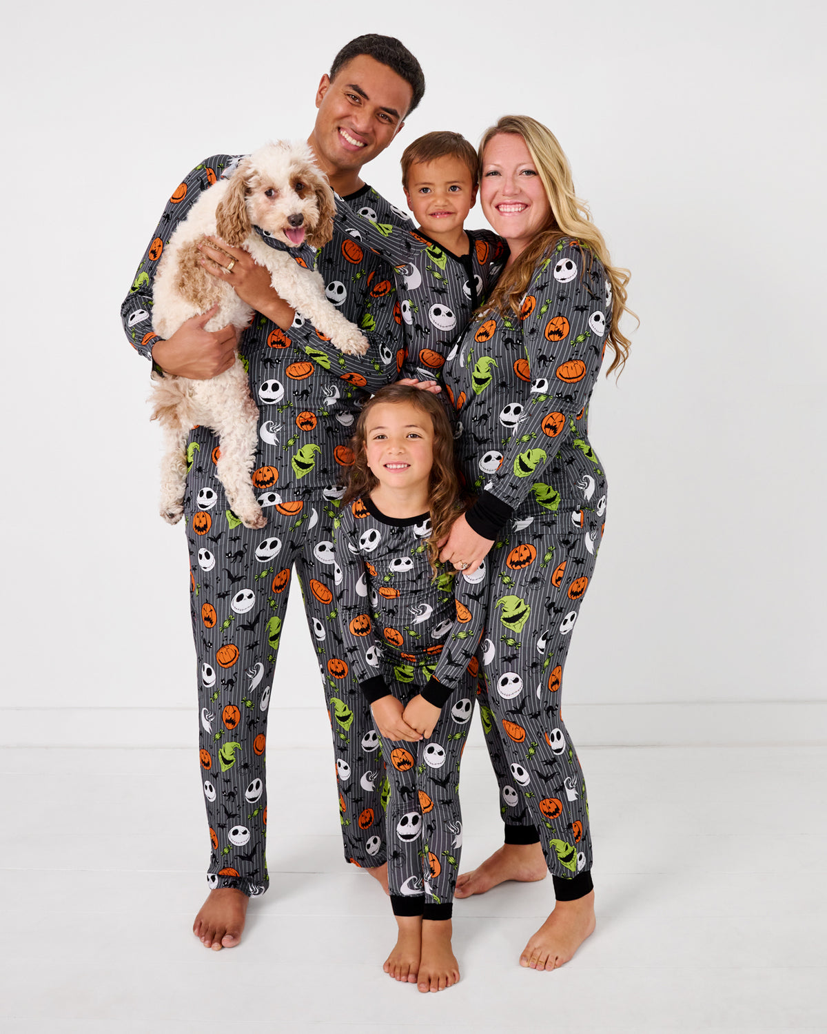 Family of four and their dog wearing matching Disney The Nightmare Before Christmas halloween themed pajamas
