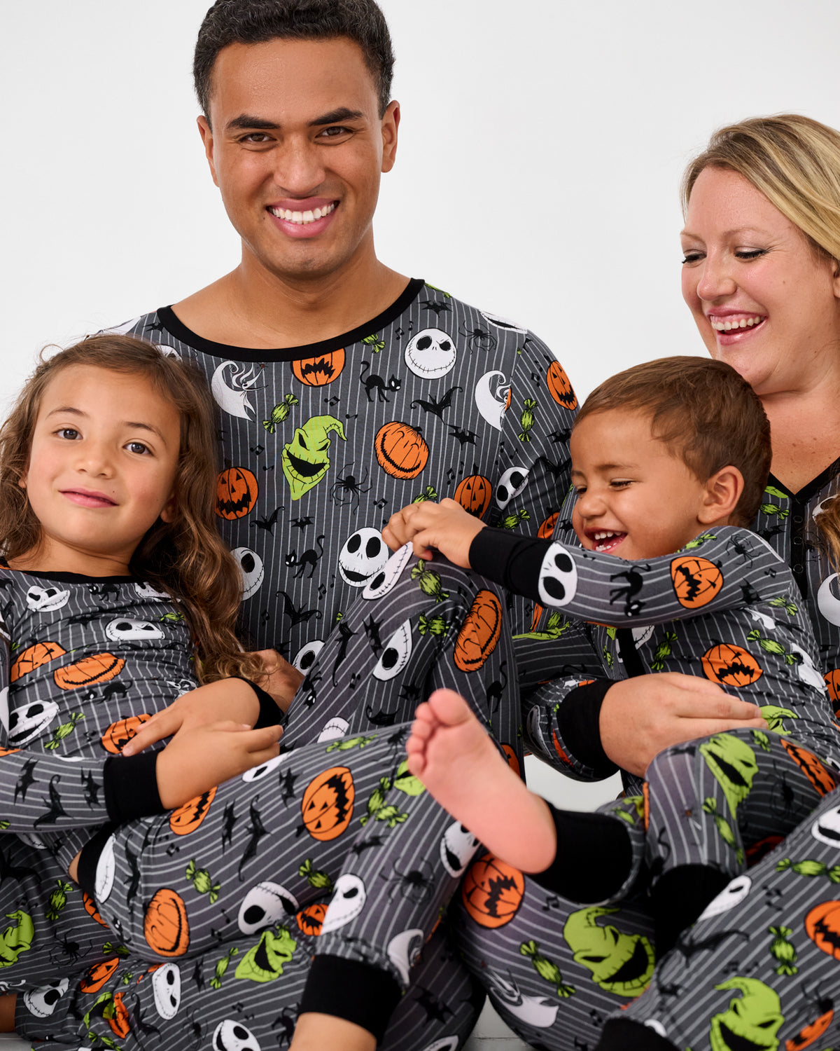 Family of four wearing matching Disney The Nightmare Before Christmas halloween pajamas