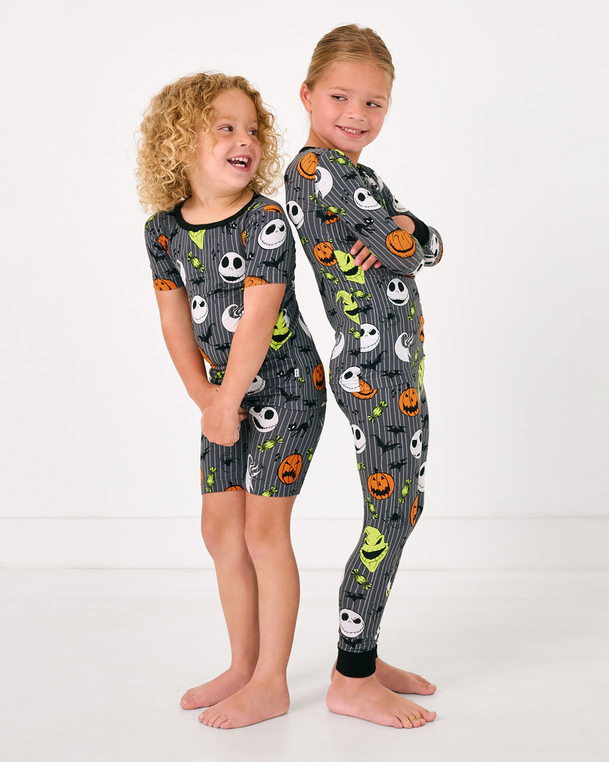 Two children back to back wearing matching Disney The Nightmare Before Christmas Two-Piece Pajama Sets