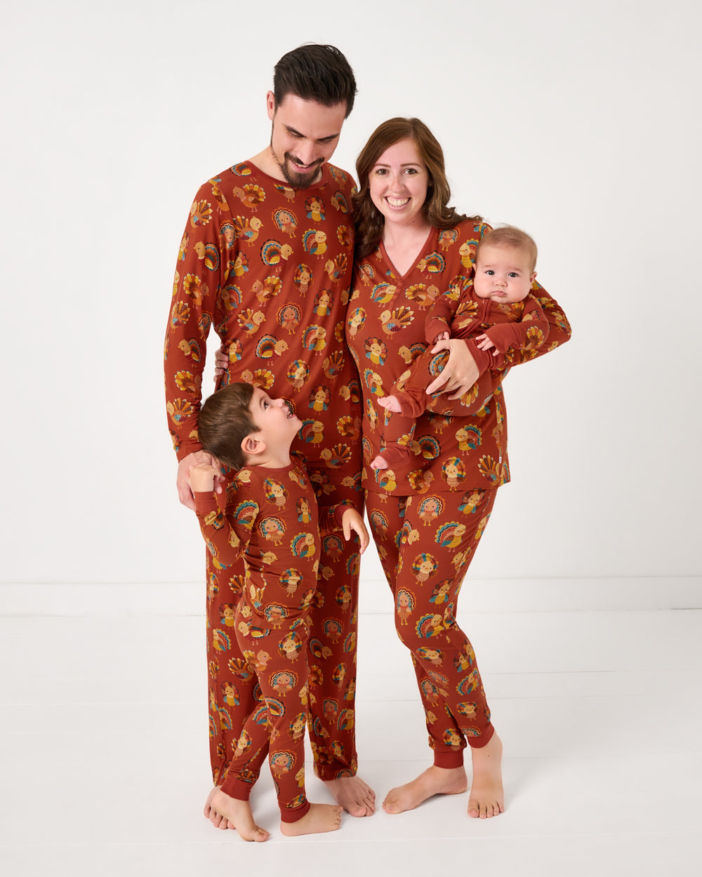 Family of four wearing matching Grateful Gobbles bamboo pajamas