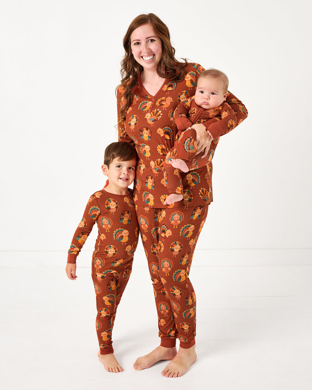 Mother and two children wearing matching Grateful Gobbles bamboo pajamas