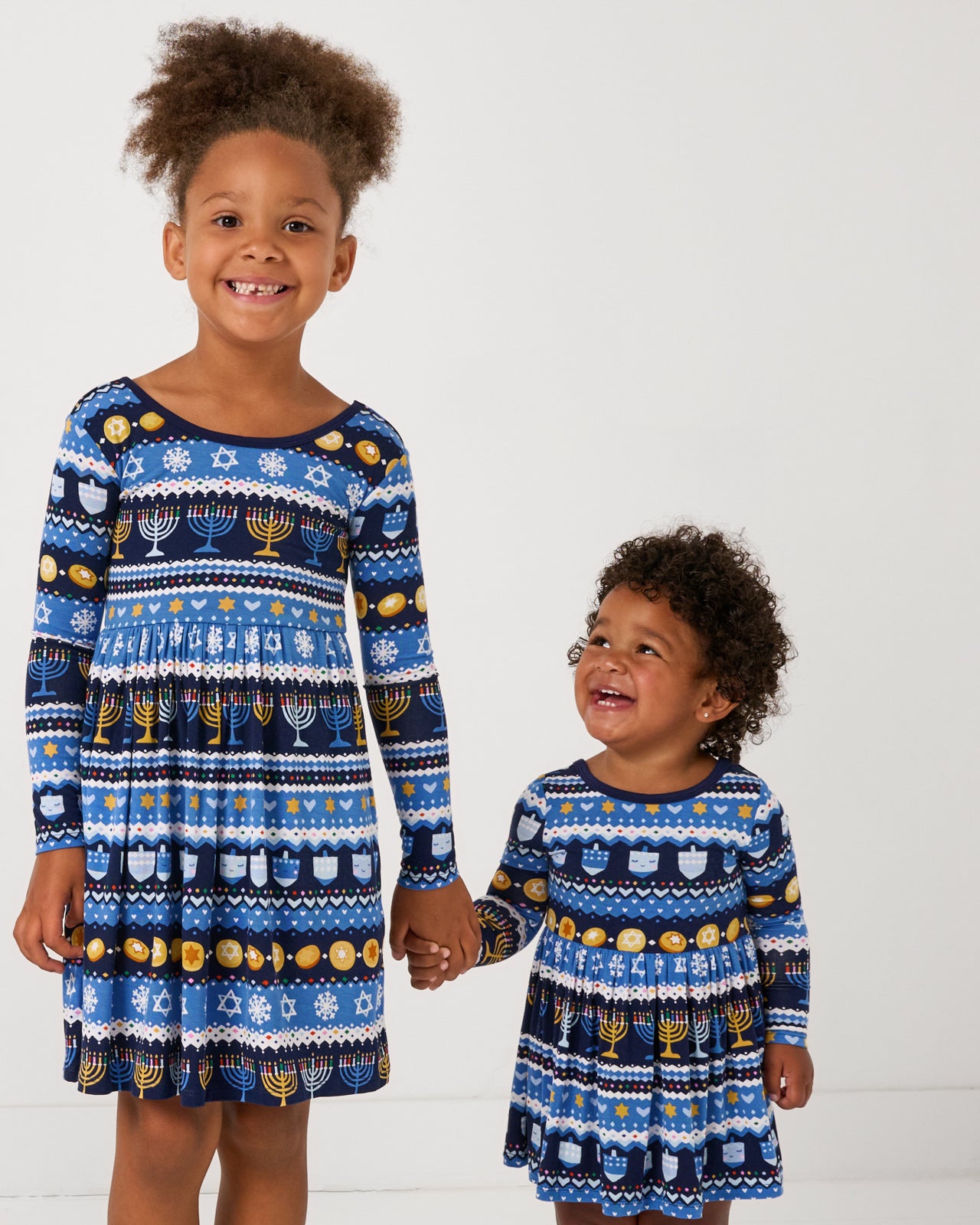 Two children wearing matching Hanukkah Fair Isle Skater Dresses