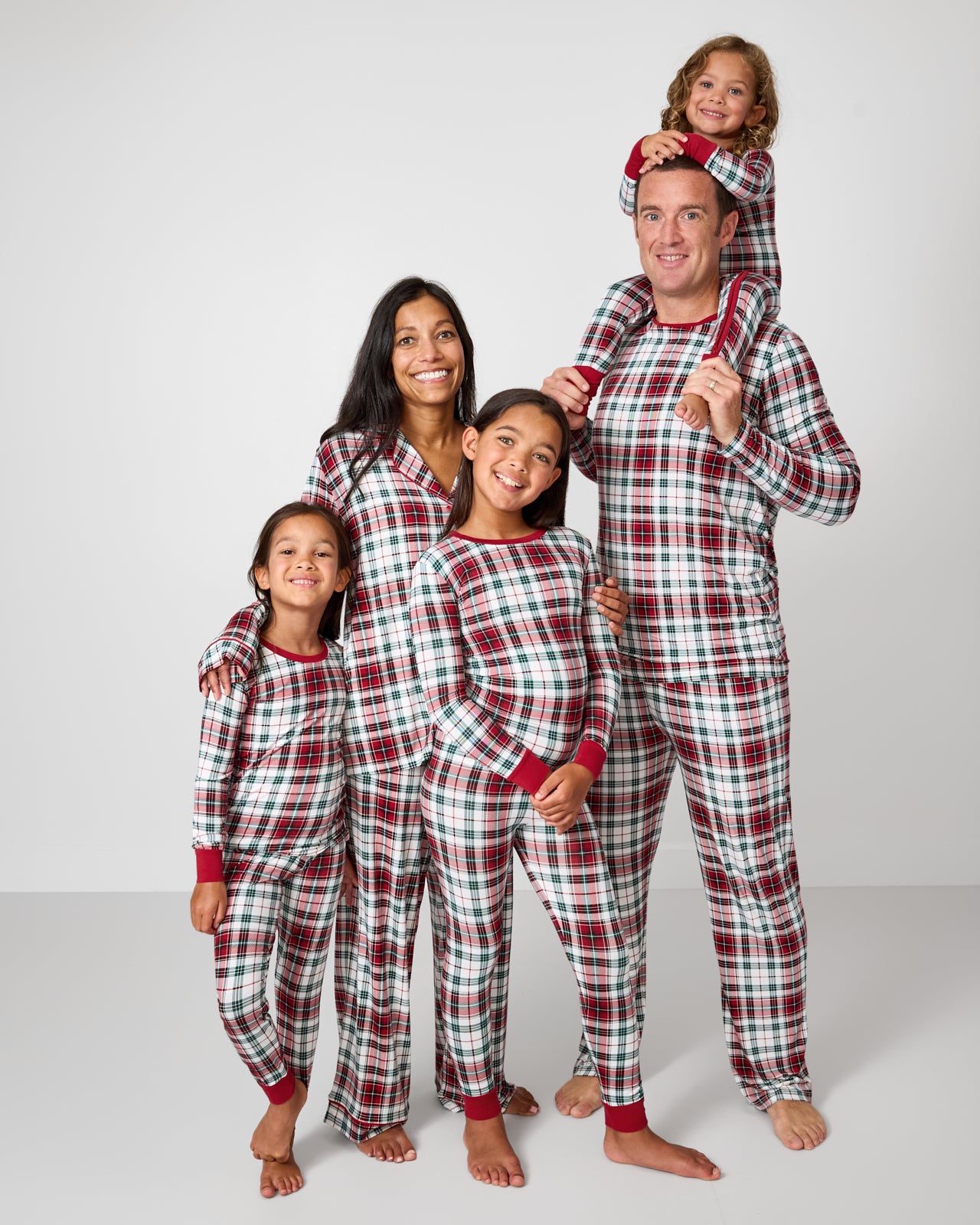 Family of five wearing matching Holly Plaid bamboo pajamas