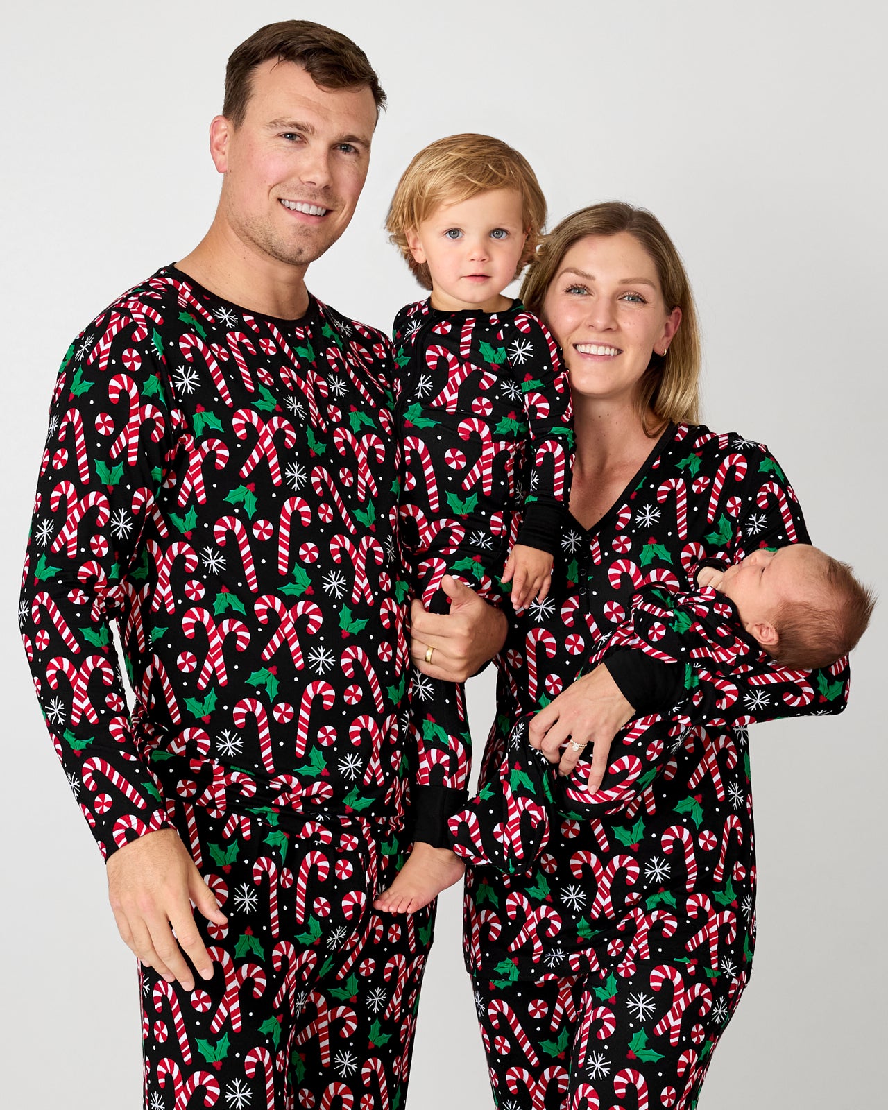 Family of four wearing matching Merry Mints pajamas