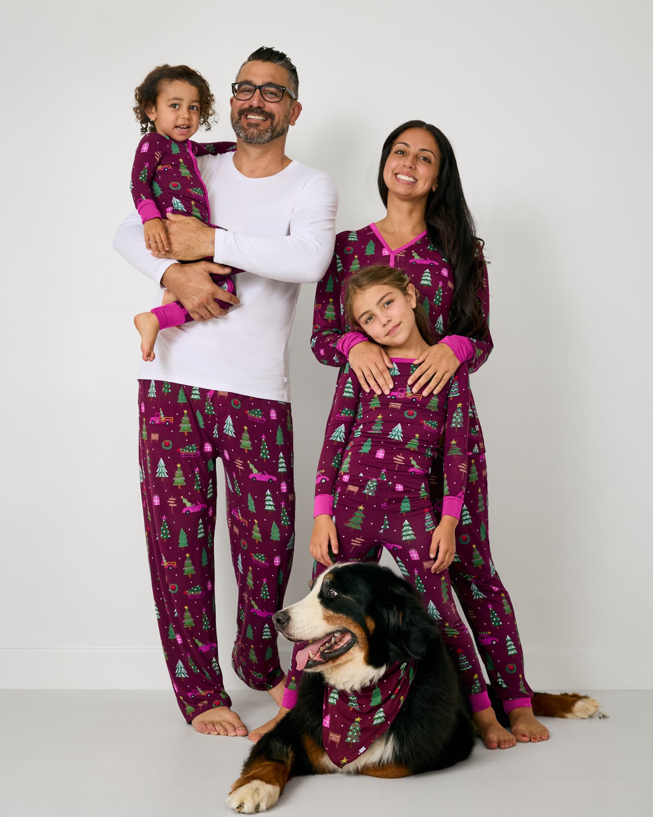 Family of four and their dog wearing matching Cranberry Tree Traffic pajamas