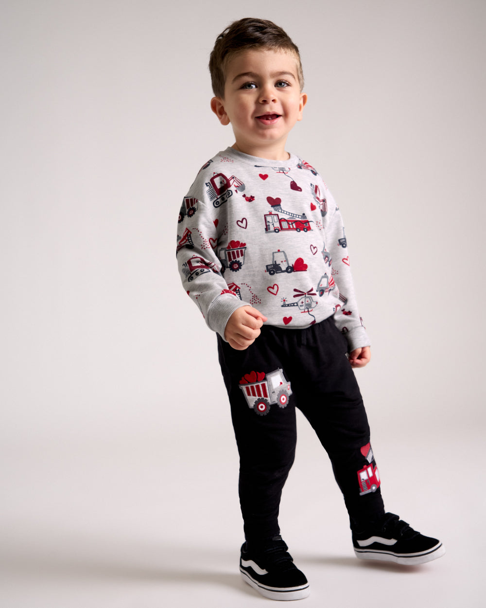 Standing boy wearing the Loads of Love Easy Crewneck Sweatshirt with matching joggers