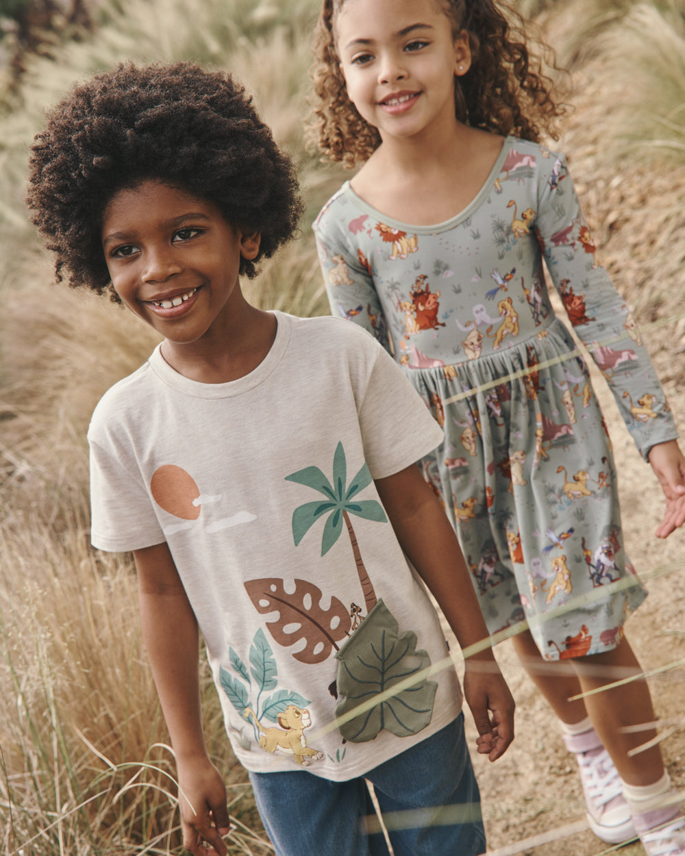 Two children wearing play styles from the Disney Lion King collection