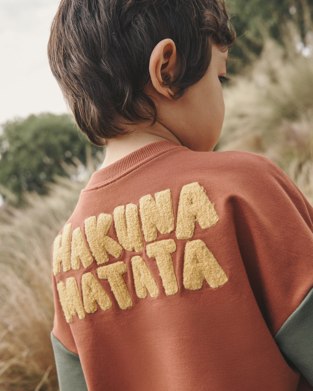Close up of the Hakuna Matata embroidery on the Disney Jungle Treasures Drop Shoulder Crewneck