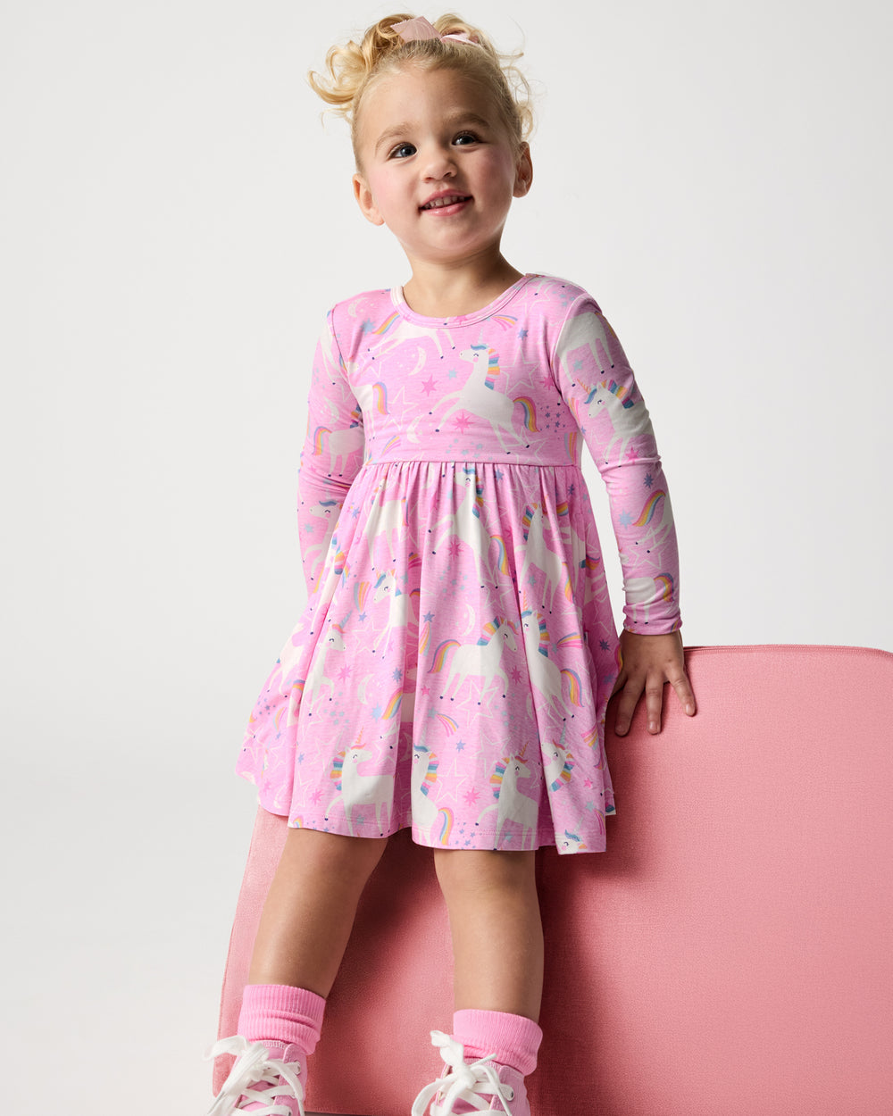 Girl wearing the Unicorn Dance Twirl Dress on a white background