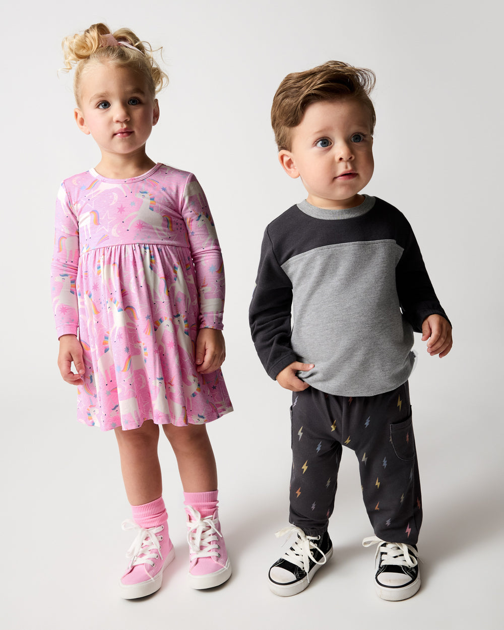 Two kids wearing Unicorn and Bolt styles from the Winter Play collection