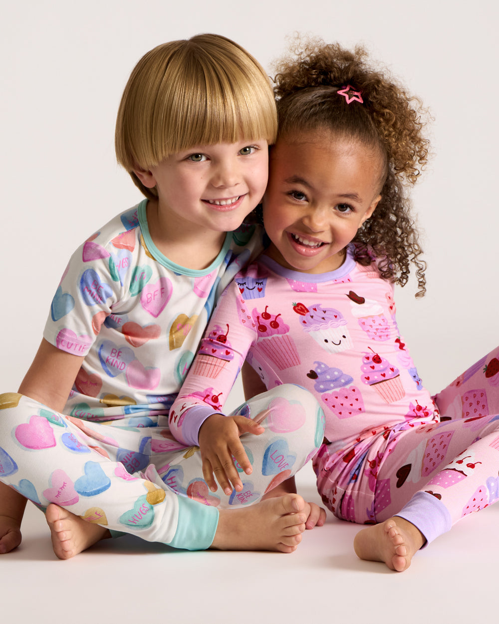 Two children wearing Valentines Day themed bamboo PJs