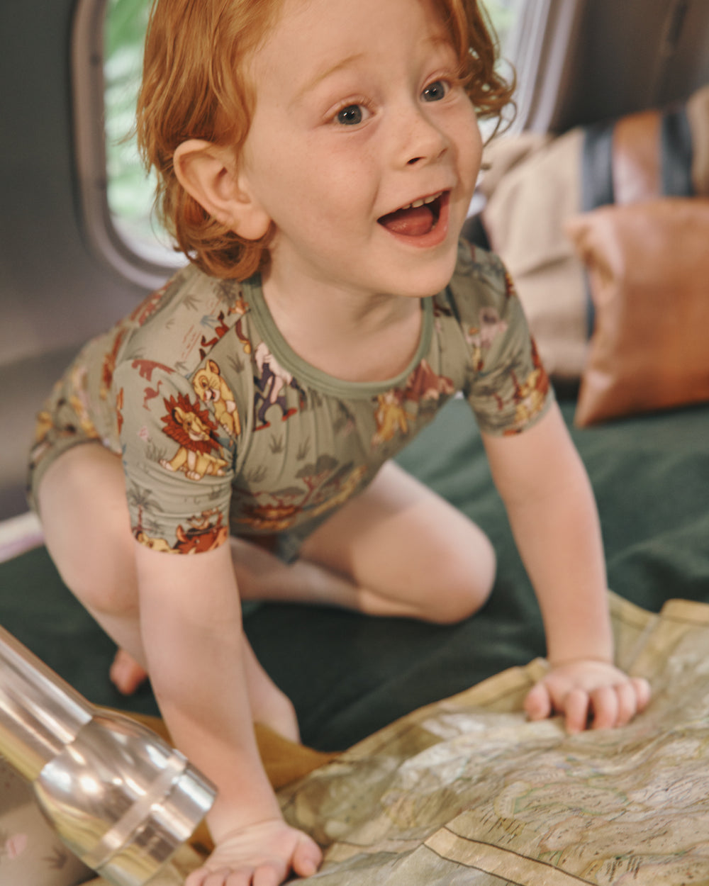 Boy wearing the Disney Simba's Safari Two-Piece Pajama Set in a vintage camper