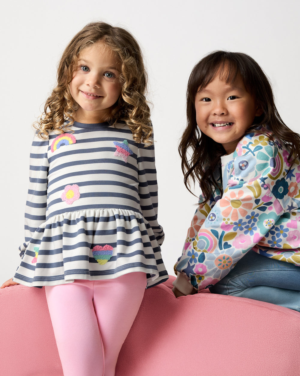 Two girls wearing tops from the Winter Play drop