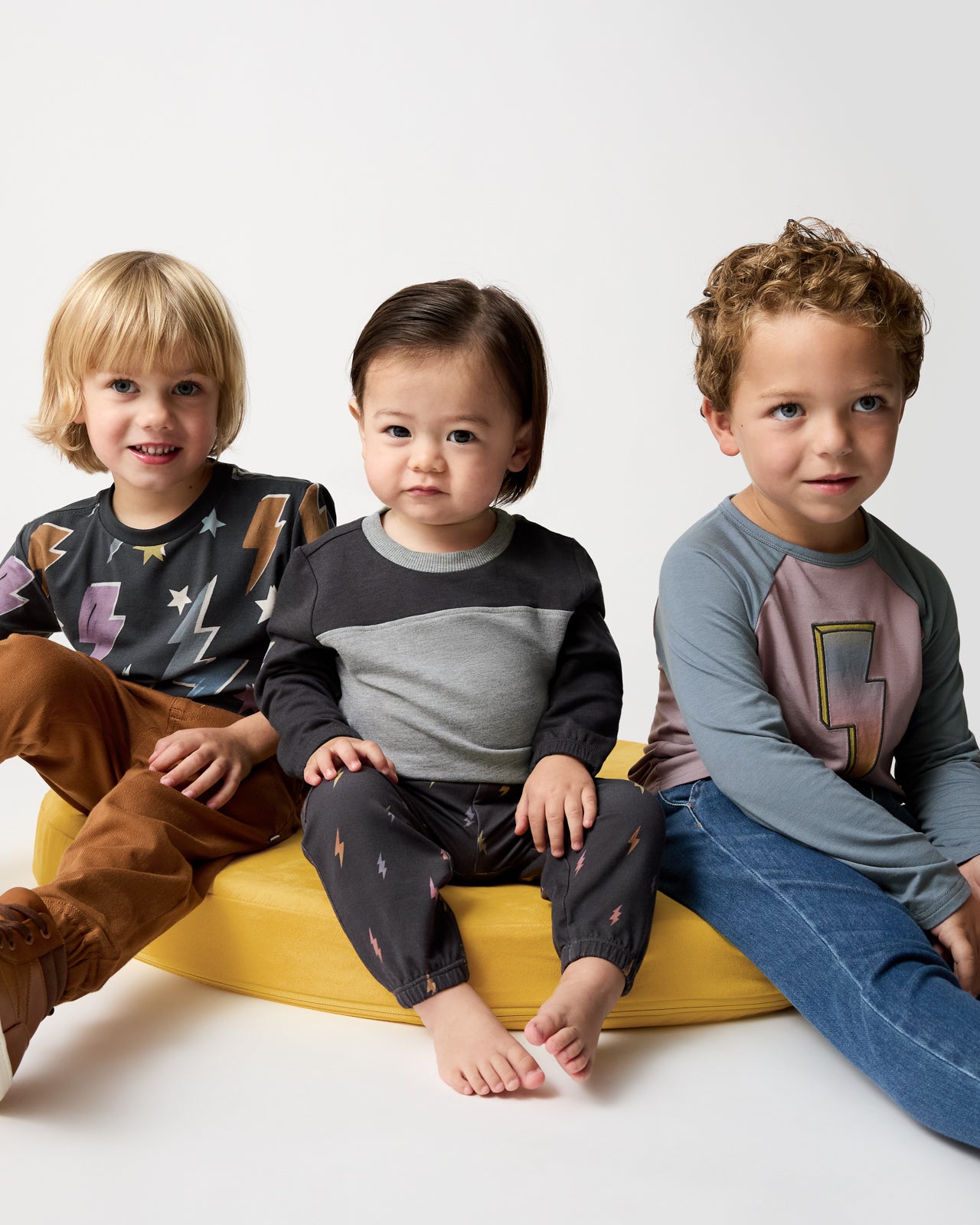 Three boys wearing lightning bolt styles from the Winter Play collection