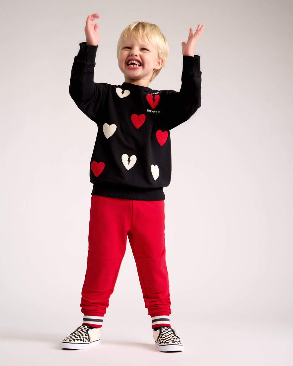 Boy wearing the Candy Red Jogger with the Rebel Hearts crewneck
