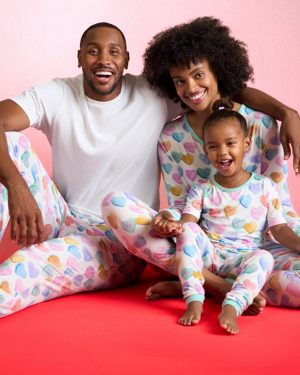 Family of three wearing matching Candy Cuties Valentines Day PJs
