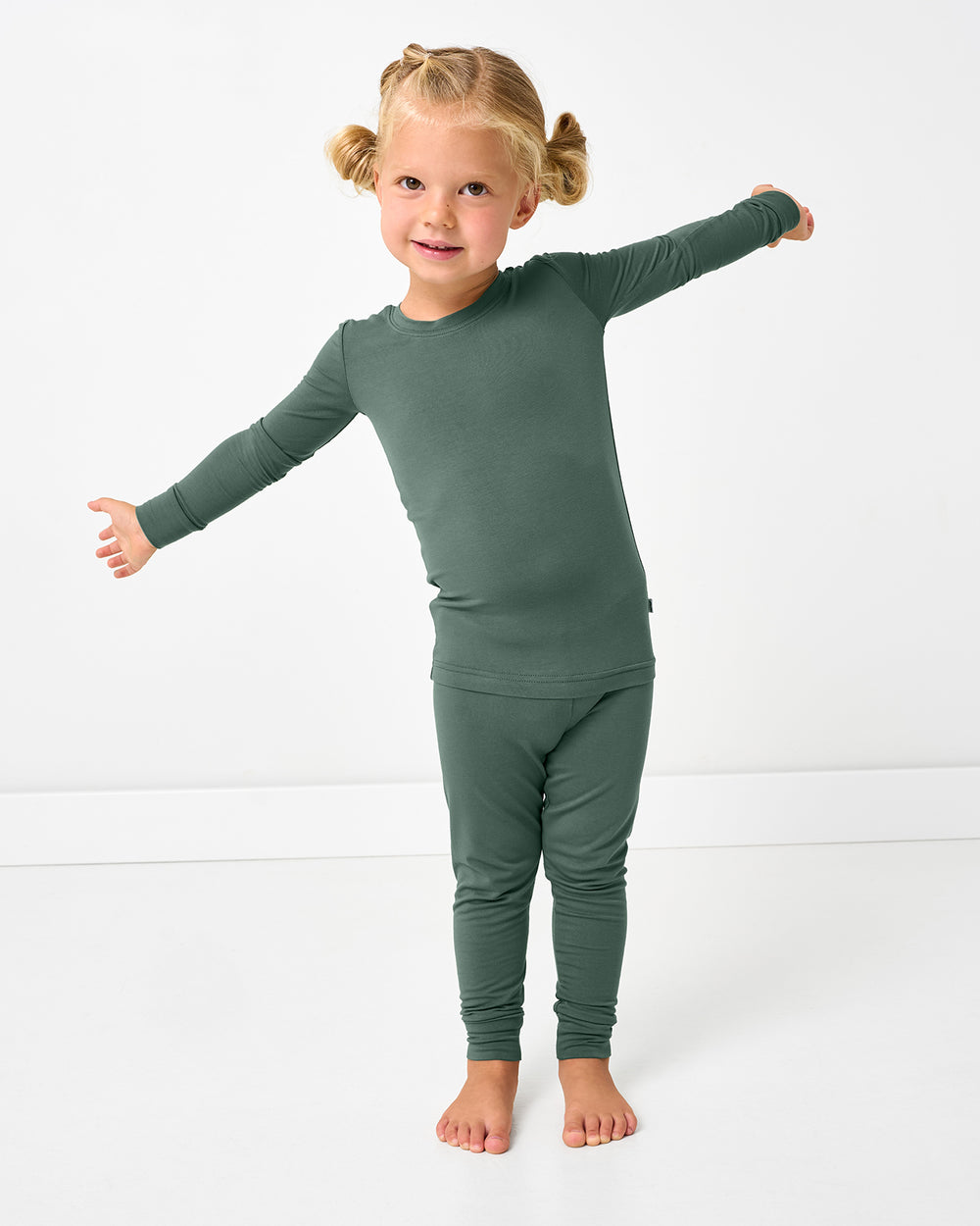Posing girl wearing the Grove Green Two-Piece Pajama Set