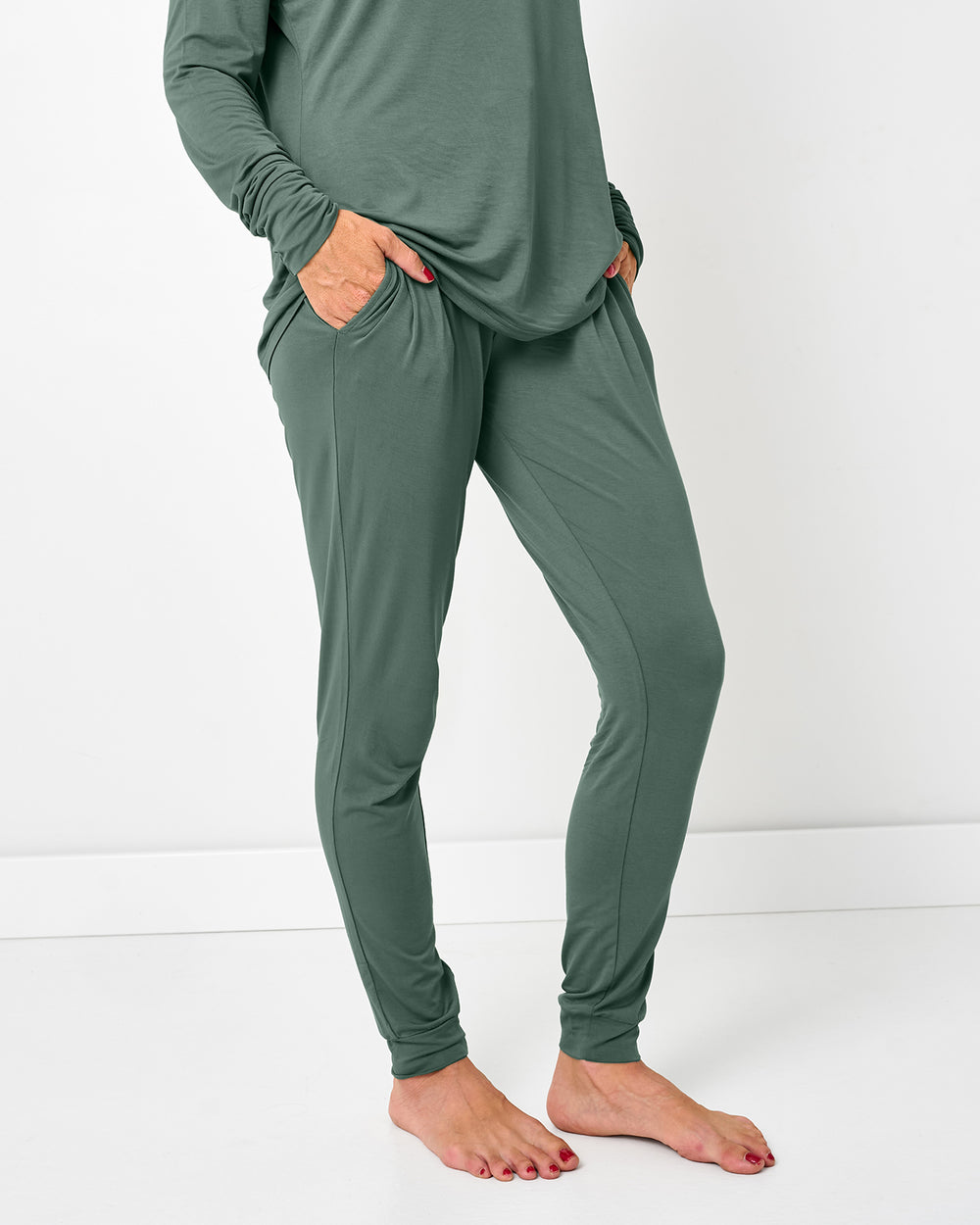 Standing woman wearing the Grove Green Women's Pajama Pants with her hands in the pockets