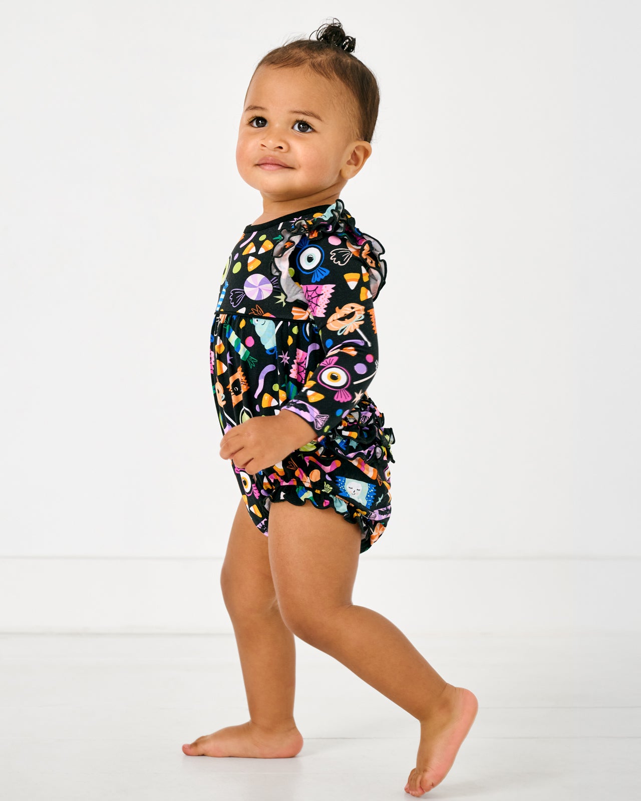 Walking toddler wearing the Halloween Haul Bubble Romper
