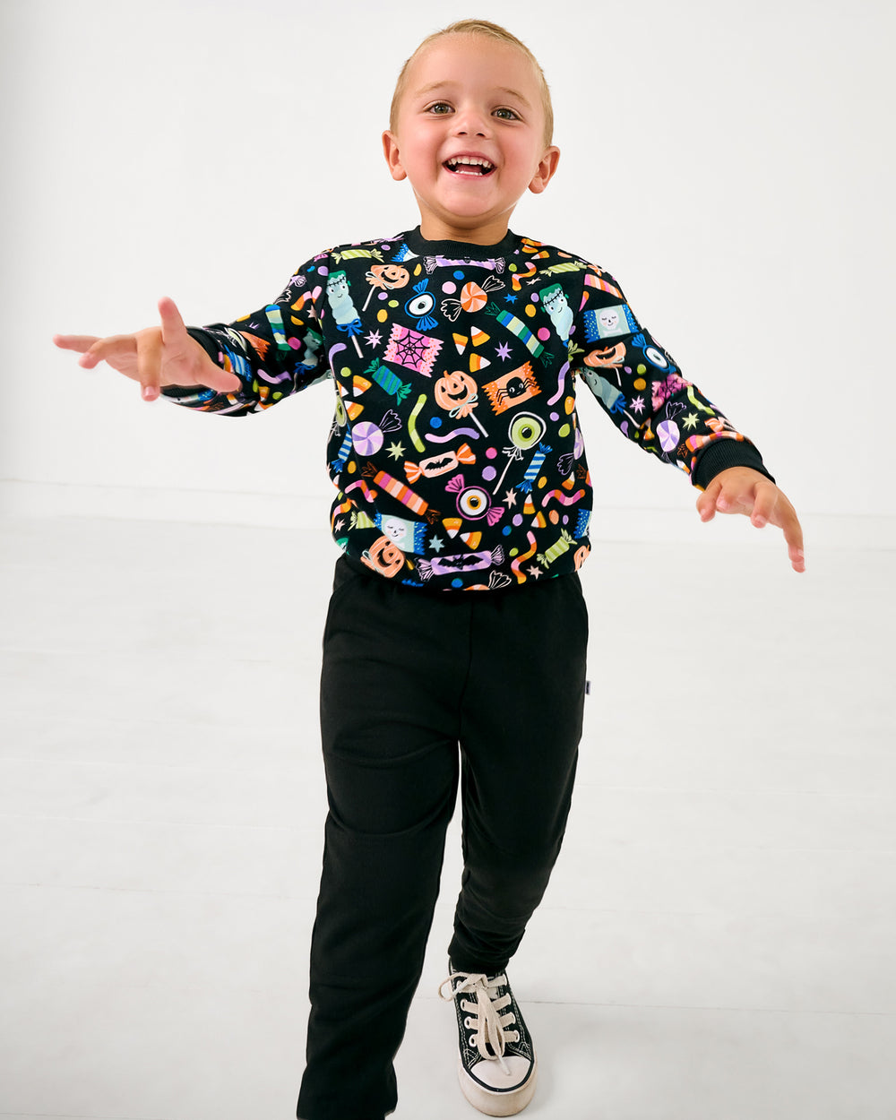 Boy wearing the Halloween Haul Crewneck Sweatshirt with black pants