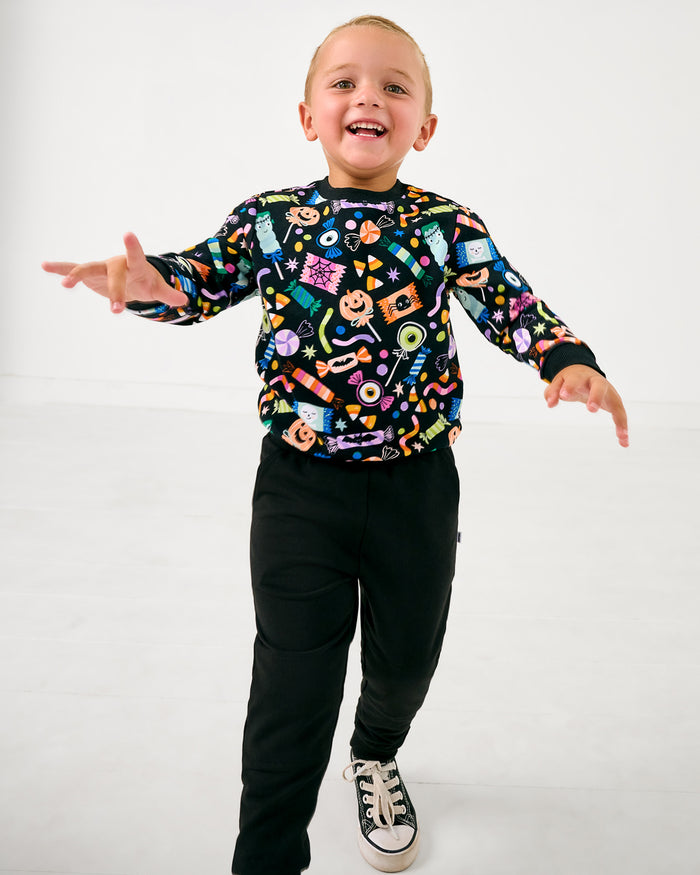 Boy wearing the Halloween Haul Crewneck Sweatshirt with black pants