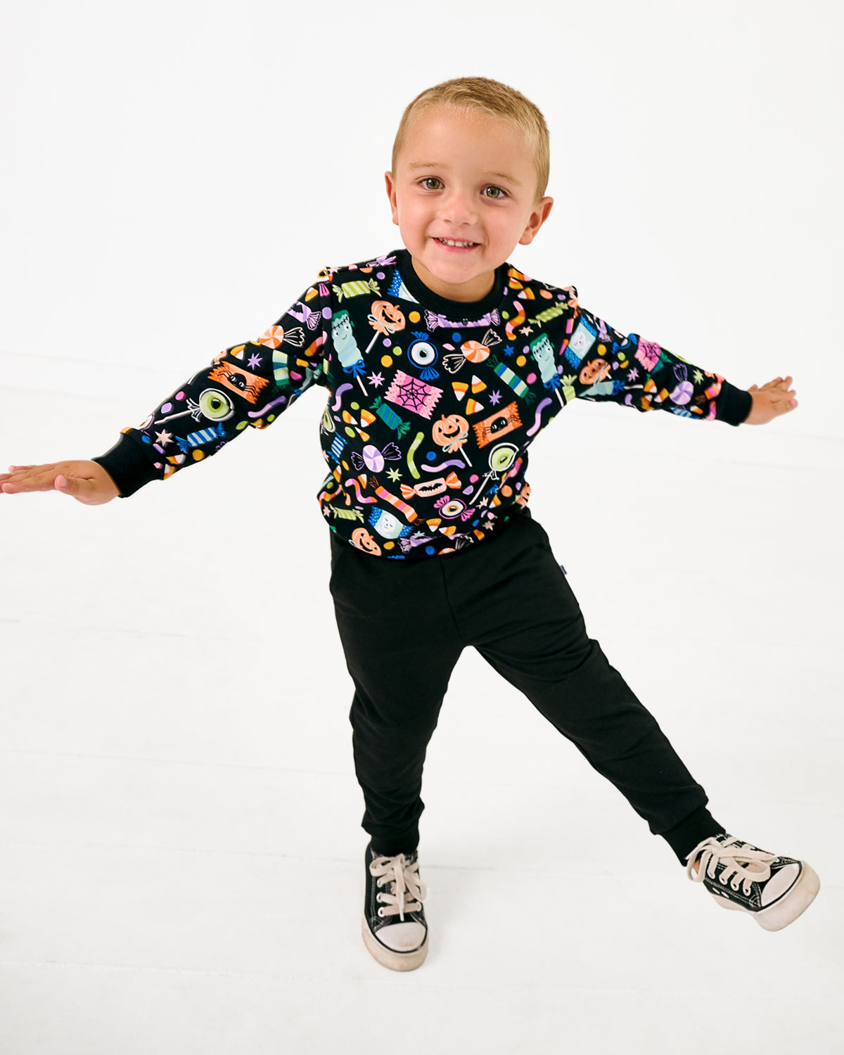 Posing boy wearing the Halloween Haul Crewneck Sweatshirt