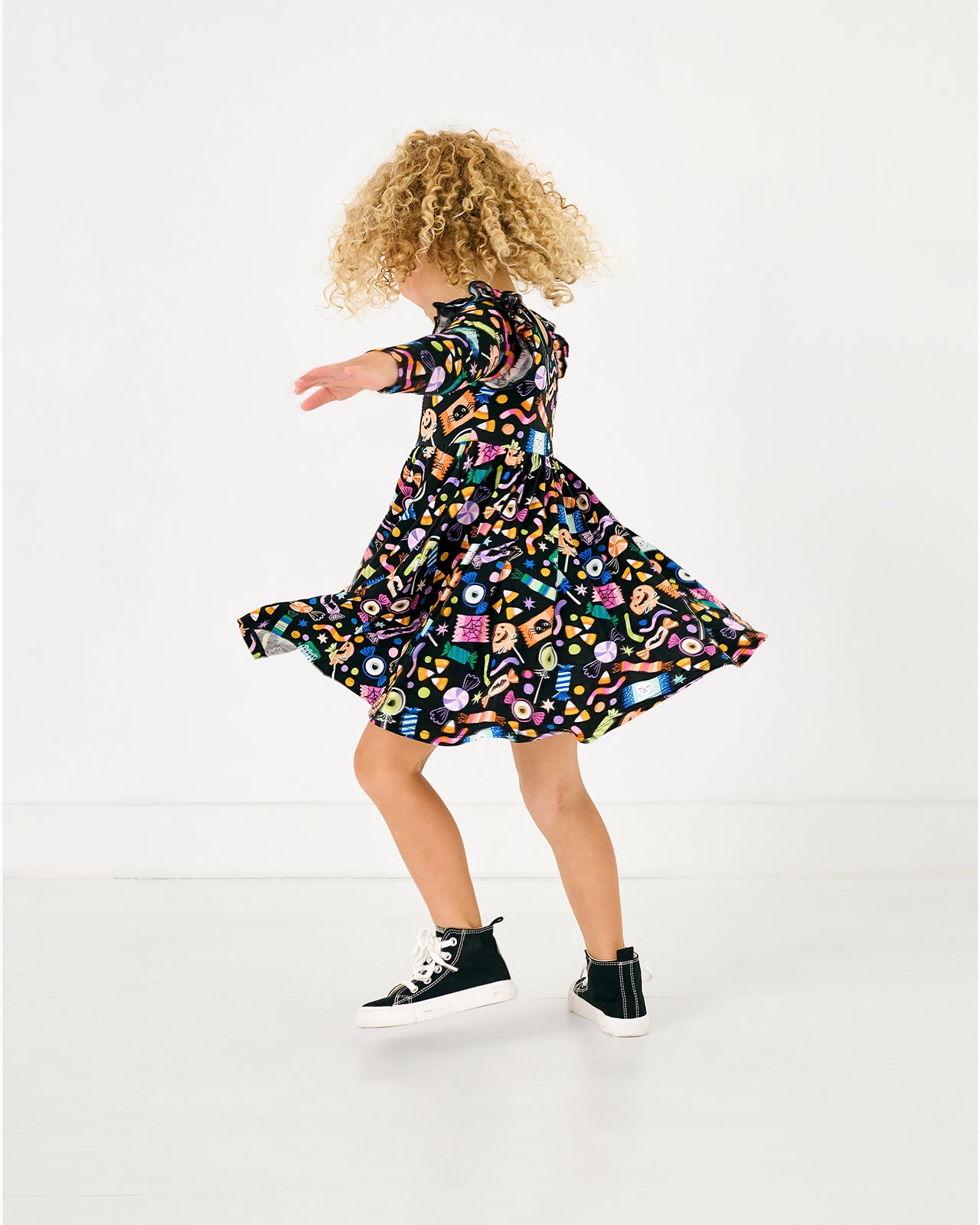 Twirling girl wearing the Halloween Haul Flutter Twirl Dress