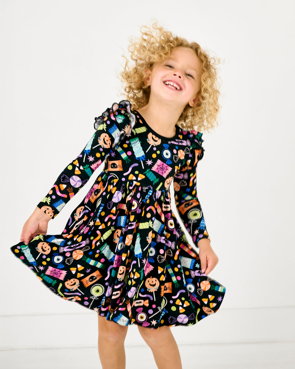 Child in motion wearing the Halloween Haul Flutter Twirl Dress
