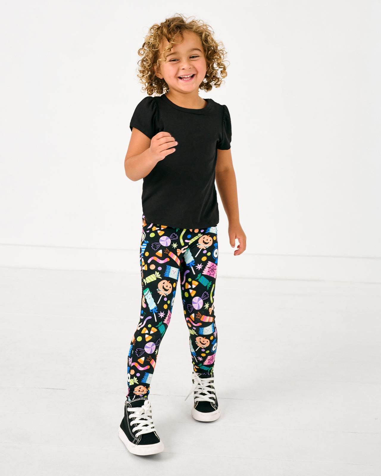 Standing girl wearing the Halloween Haul Legging with a black puff sleeve shirt