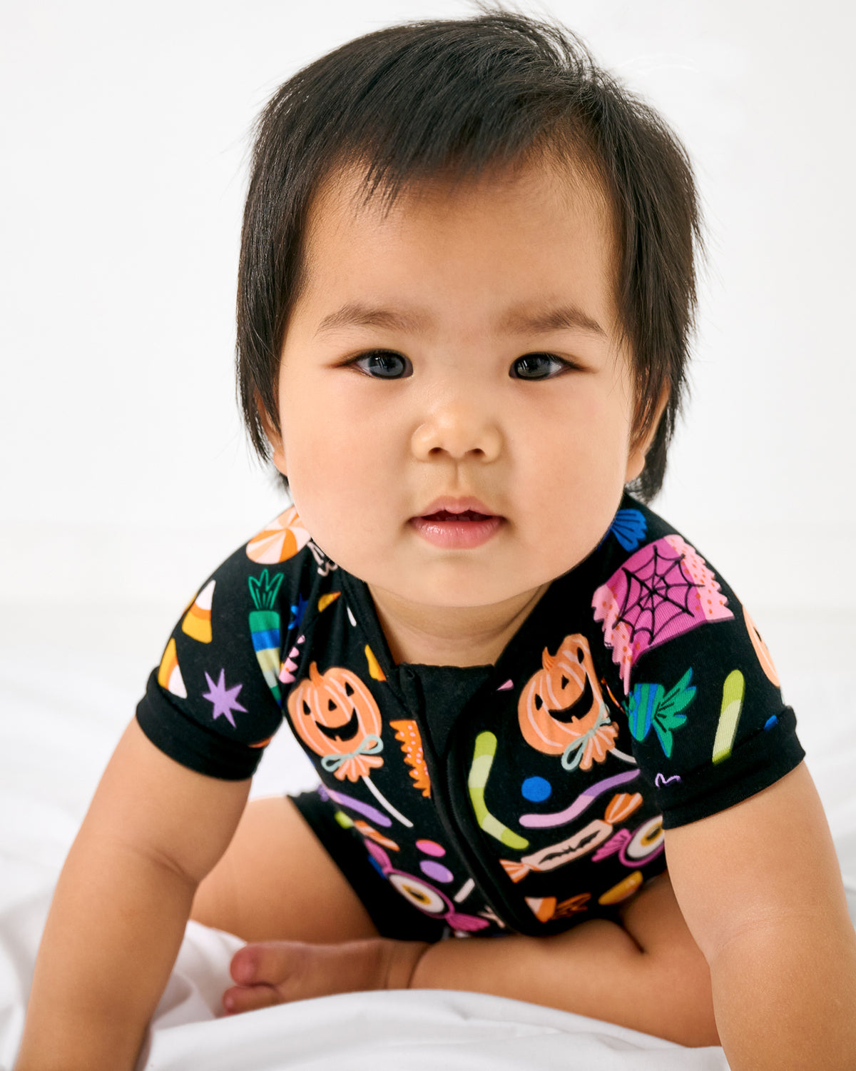 Crawling baby wearing the Halloween Haul Shorty Zippy