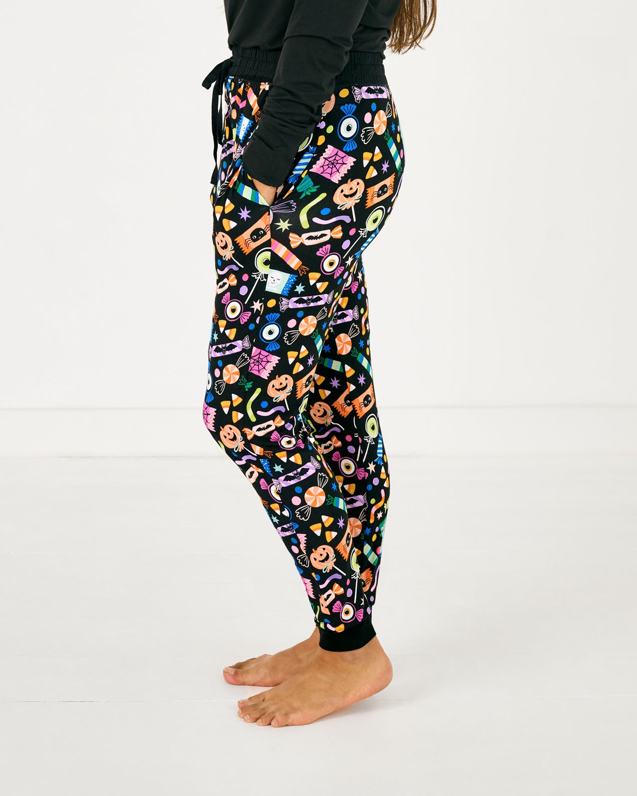 Side view of standing woman wearing the Halloween Haul Women's Pajama Pants